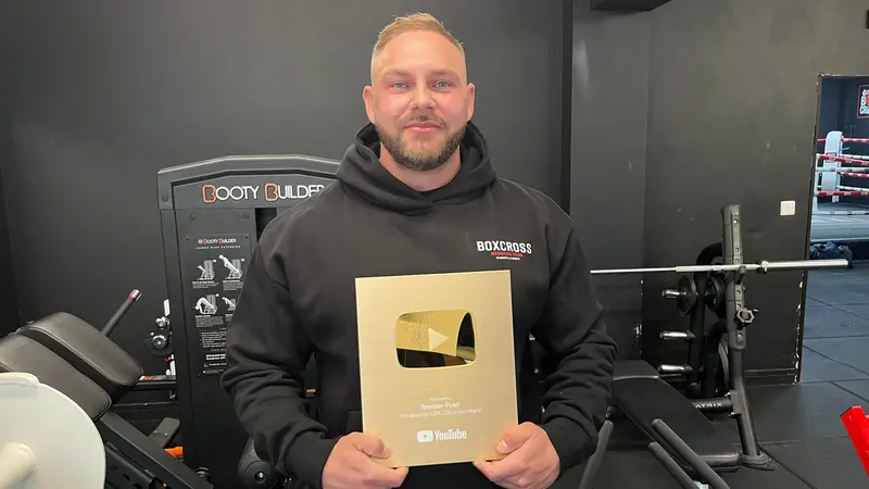 Brendan Pearl holding his YouTube Gold Play Button for 1 million subscribers